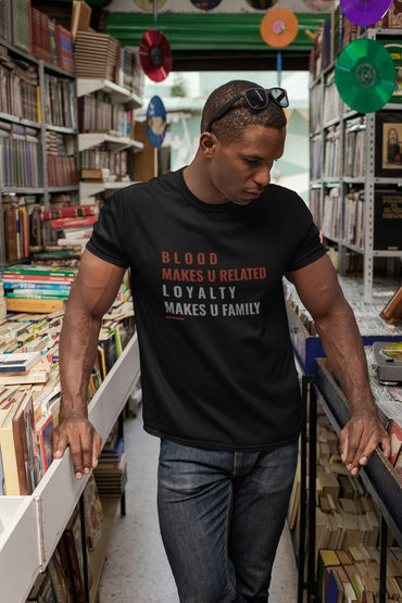 Man wearing a black t-shirt with text in a bookstore