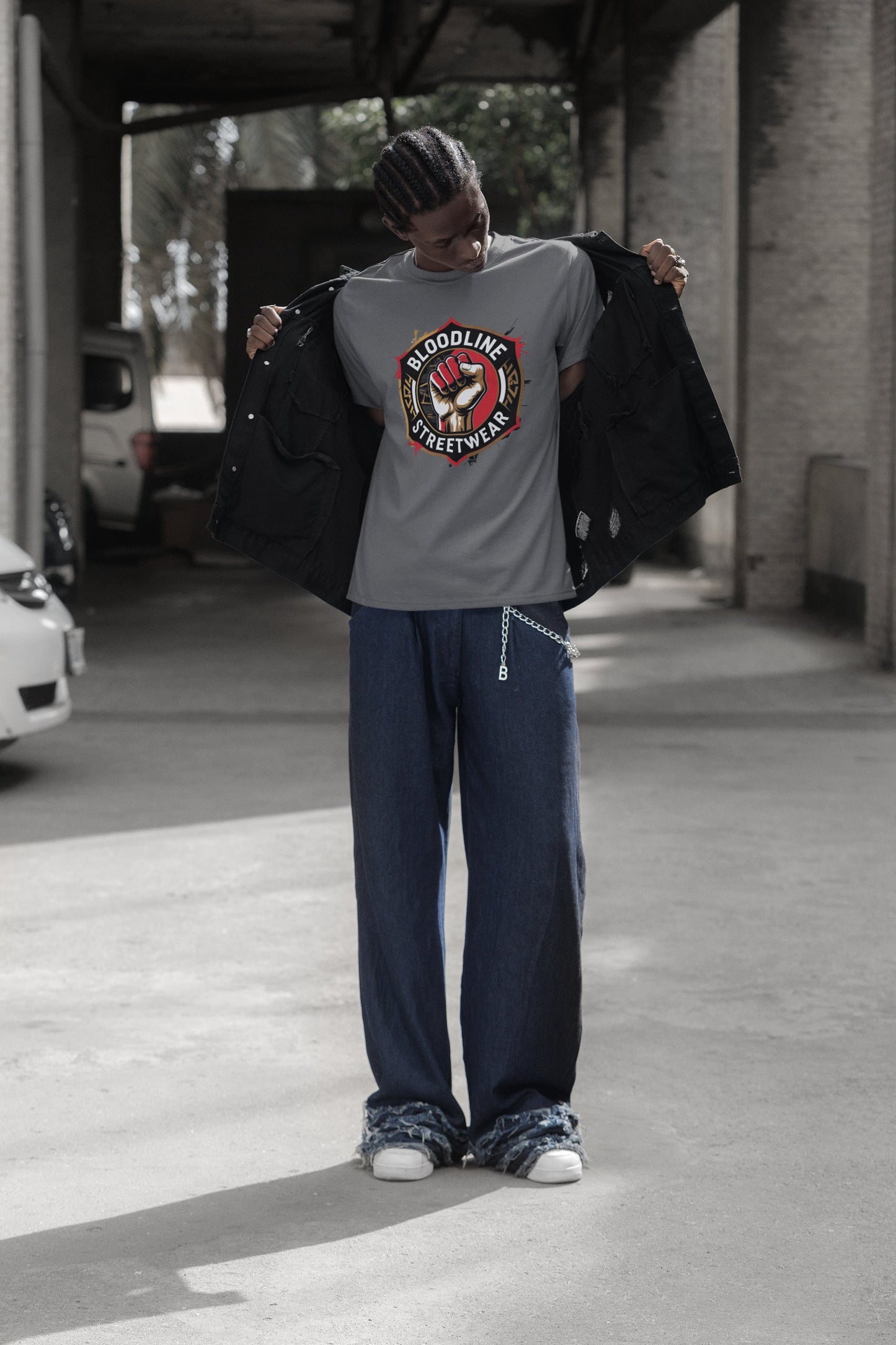 Person wearing a black sweatshirt with 'Savage' graphic and dark pants in an urban setting.