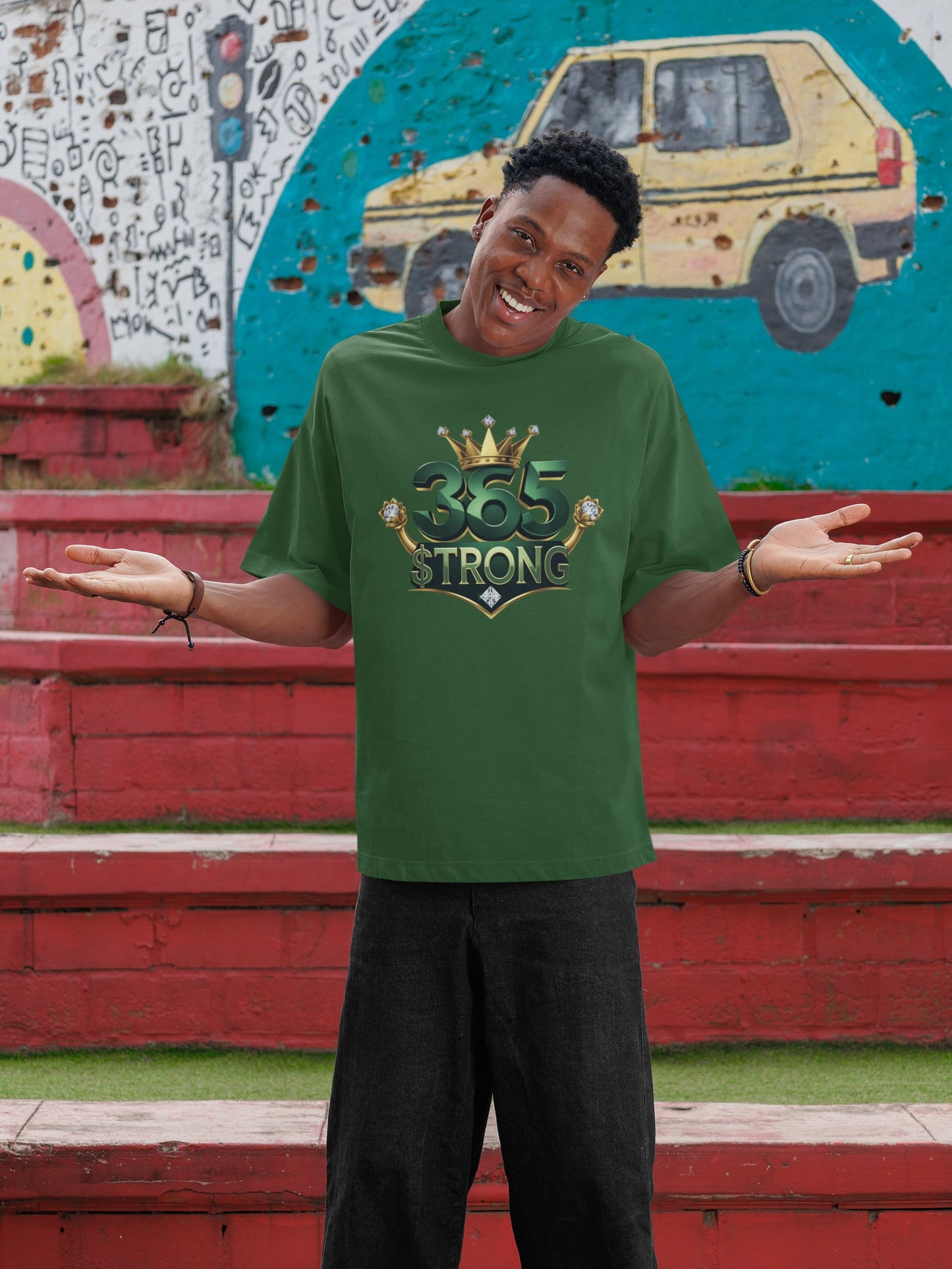 Person wearing a green t-shirt with a logo and text, standing in front of a colorful mural.