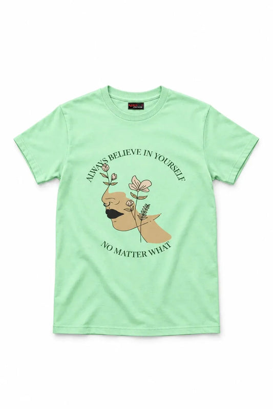 A mint green short-sleeve t-shirt with a graphic print of a hand holding a flower, surrounded by the text 'ALWAYS BELIEVE IN YOURSELF' and 'NO MATTER WHAT'.