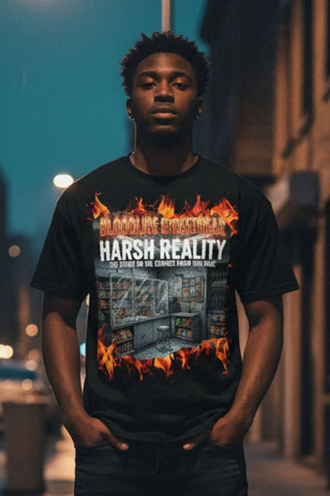 Person wearing a black t-shirt with graphic design and text, standing outdoors at night.
