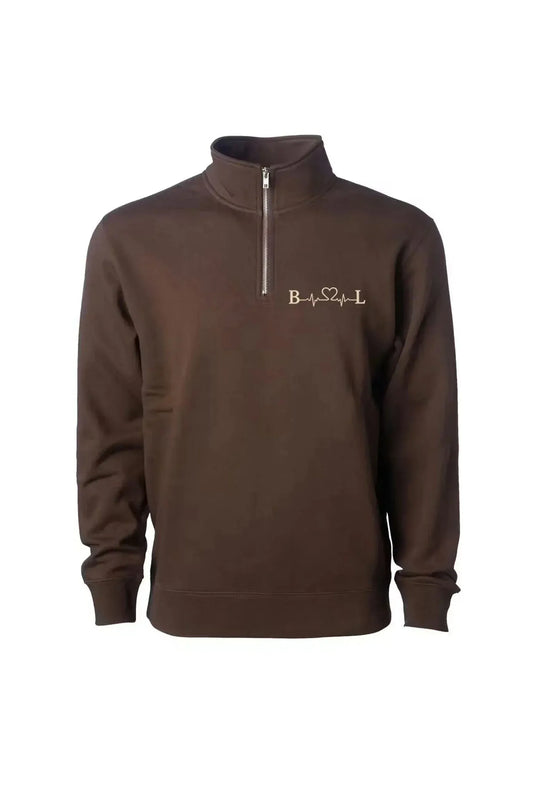 A dark brown long-sleeve quarter-zip sweatshirt with a mock neck collar, featuring a small gold embroidered logo on the left chest, displayed on a clean white background.