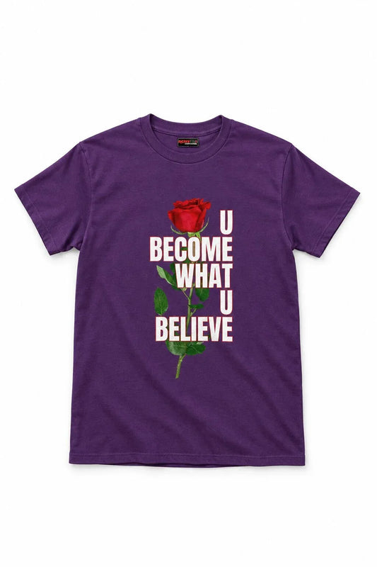 A purple short-sleeve crewneck t-shirt featuring a graphic print of a red rose and the text 'U BECOME WHAT U BELIEVE' in white and green, displayed on a clean white background.