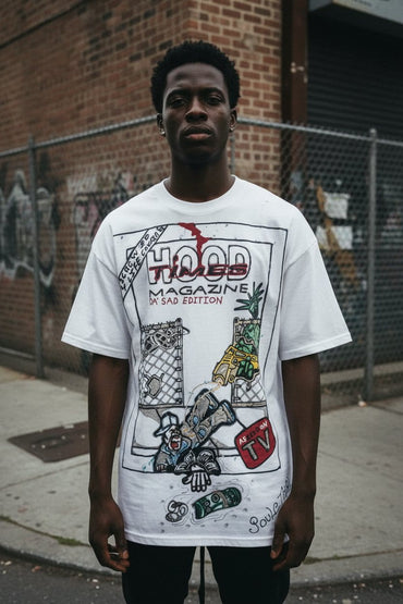 Person wearing a white t-shirt with graphic design in an urban setting