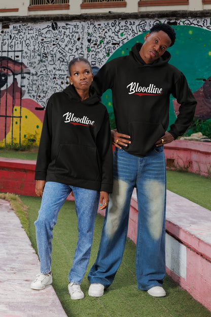 Two people wearing 'Bloodline' hoodies in front of a colorful mural.