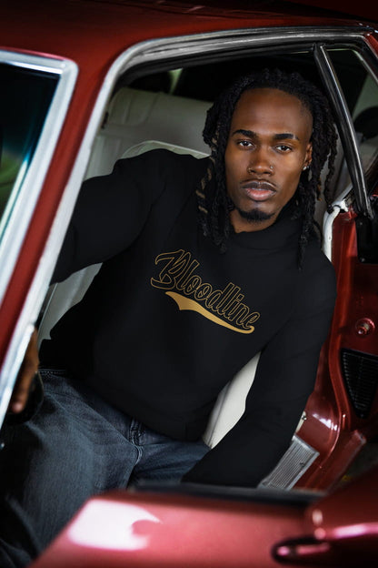 Man sitting inside a red car wearing a black sweatshirt with 'Bloodline' text.