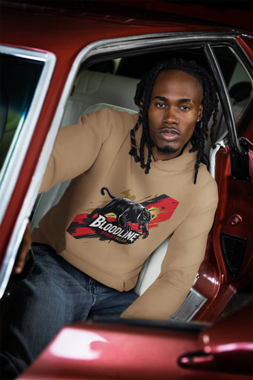Person wearing a hoodie with a graphic design sitting in a red car