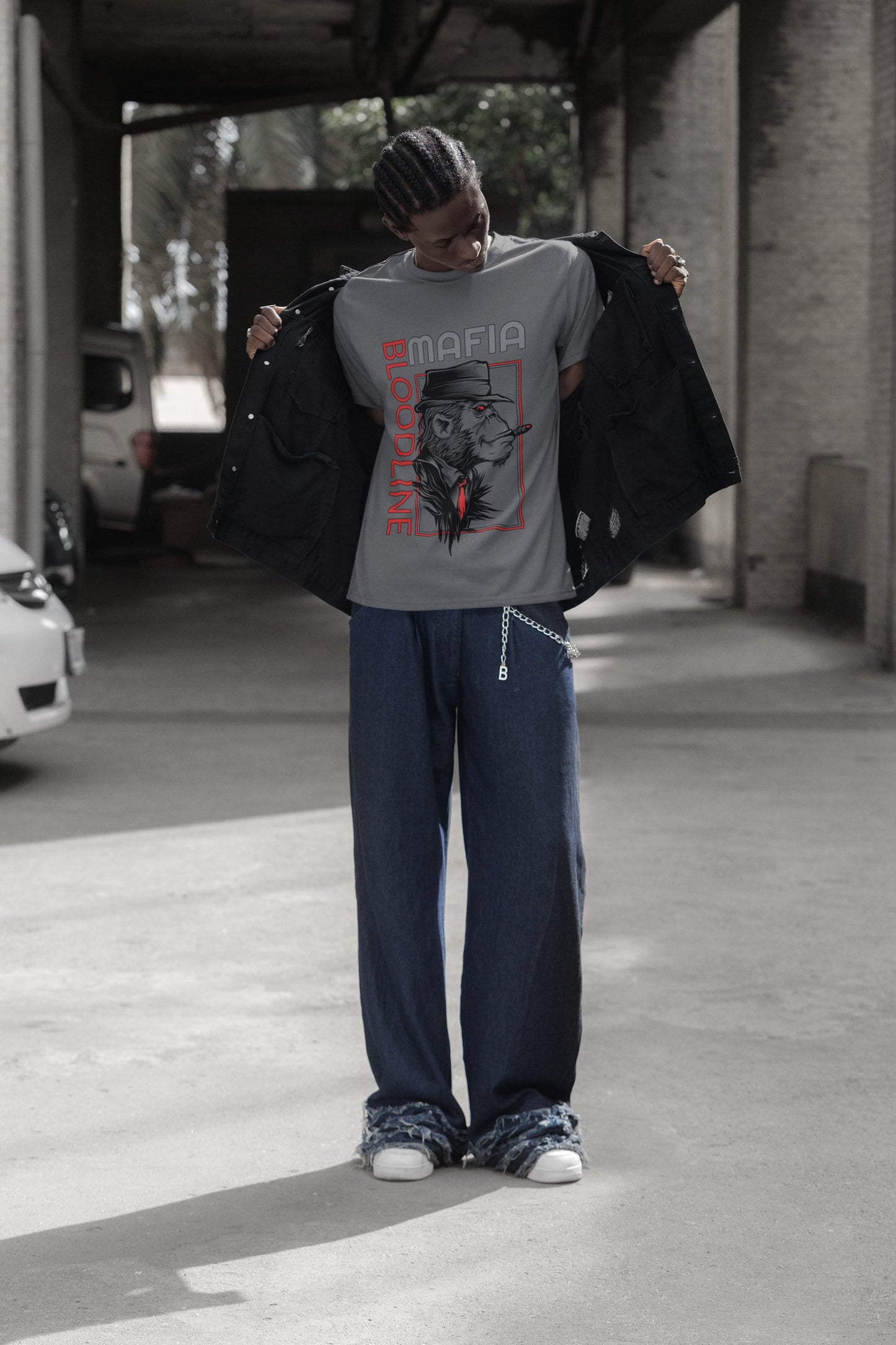 Person wearing a black sweatshirt with 'Savage' graphic and dark pants in an urban setting.