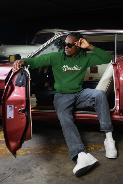 Person wearing a green 'Bloodline' hoodie sitting in a red car.