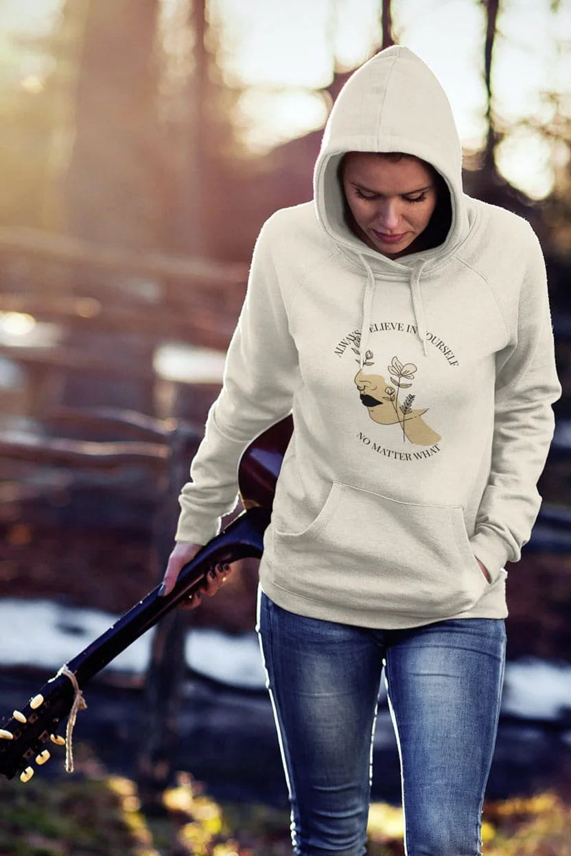 Person wearing a hoodie with a graphic design outdoors