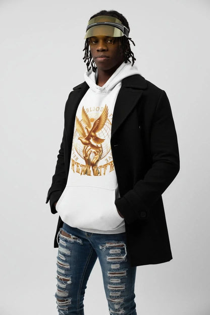 Person wearing a white hoodie with a graphic design, black coat, and ripped jeans on a plain background