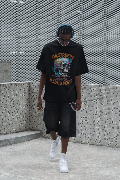 Person wearing a black graphic t-shirt and shorts walking against a textured wall.