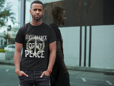 Man wearing a black t-shirt with text standing on a street.