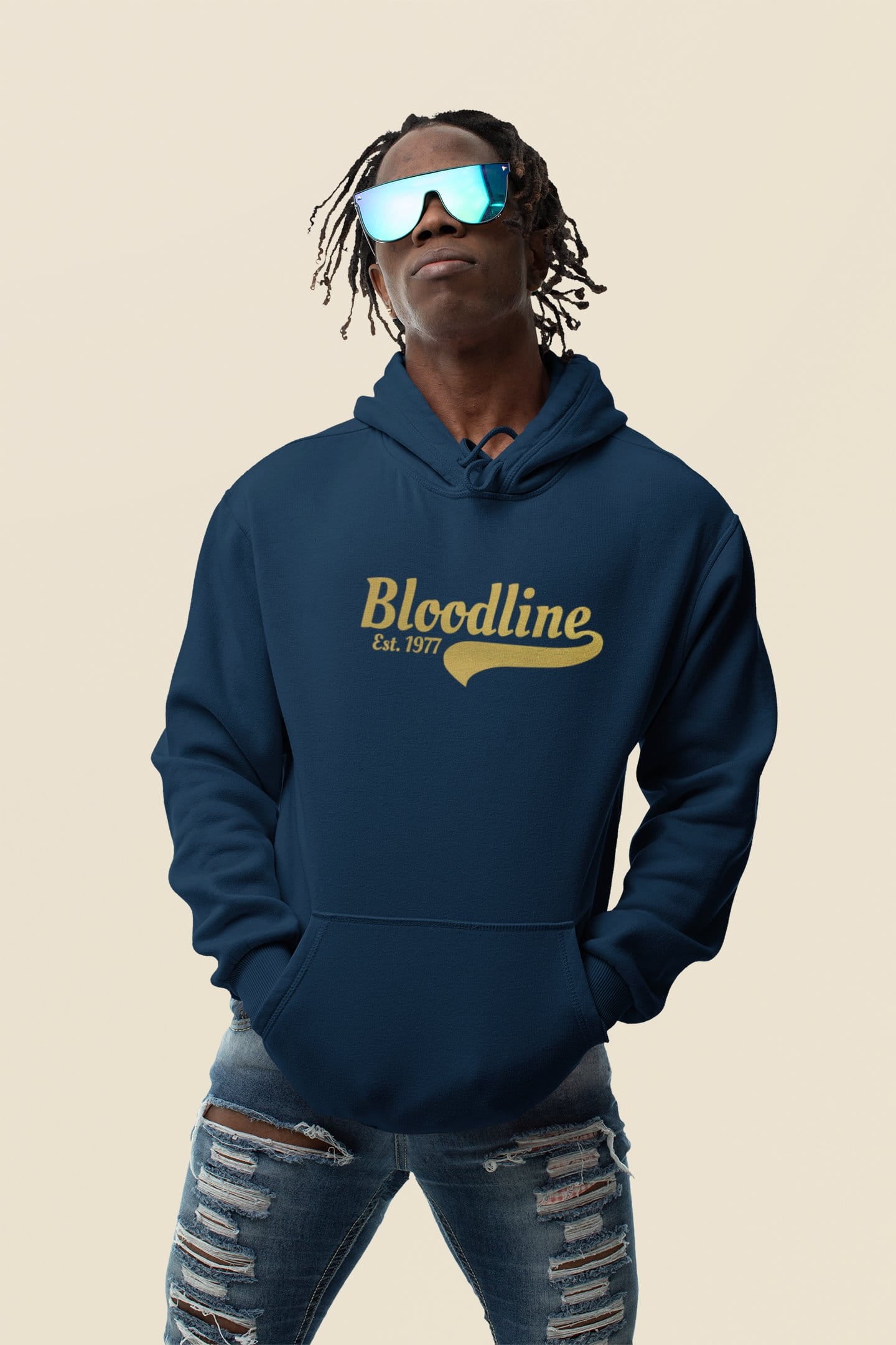 Person wearing a navy hoodie with 'Bloodline' text on a beige background