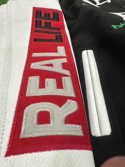 Text 'REAL LIFE' on a red, white, and black background