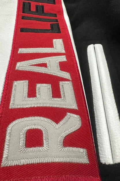 Red belt with 'REALIFE' embroidery on a black background