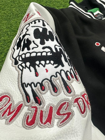 Close-up of a jacket with a skull design and text on a grass background