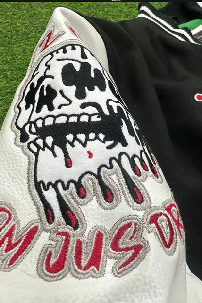 Close-up of a jacket with a skull design and text on a grass background
