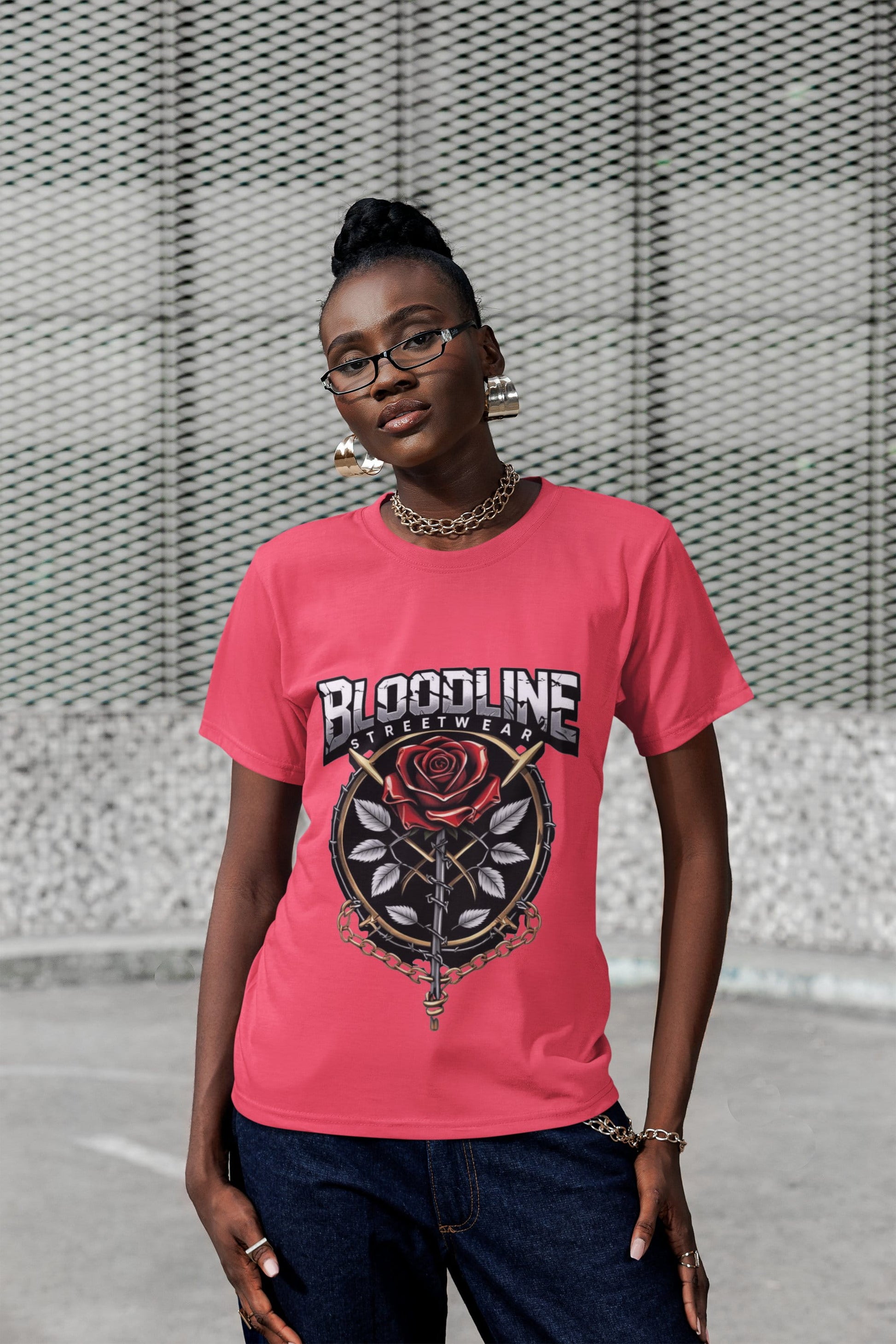 Person wearing a pink t-shirt with a graphic design in an urban setting