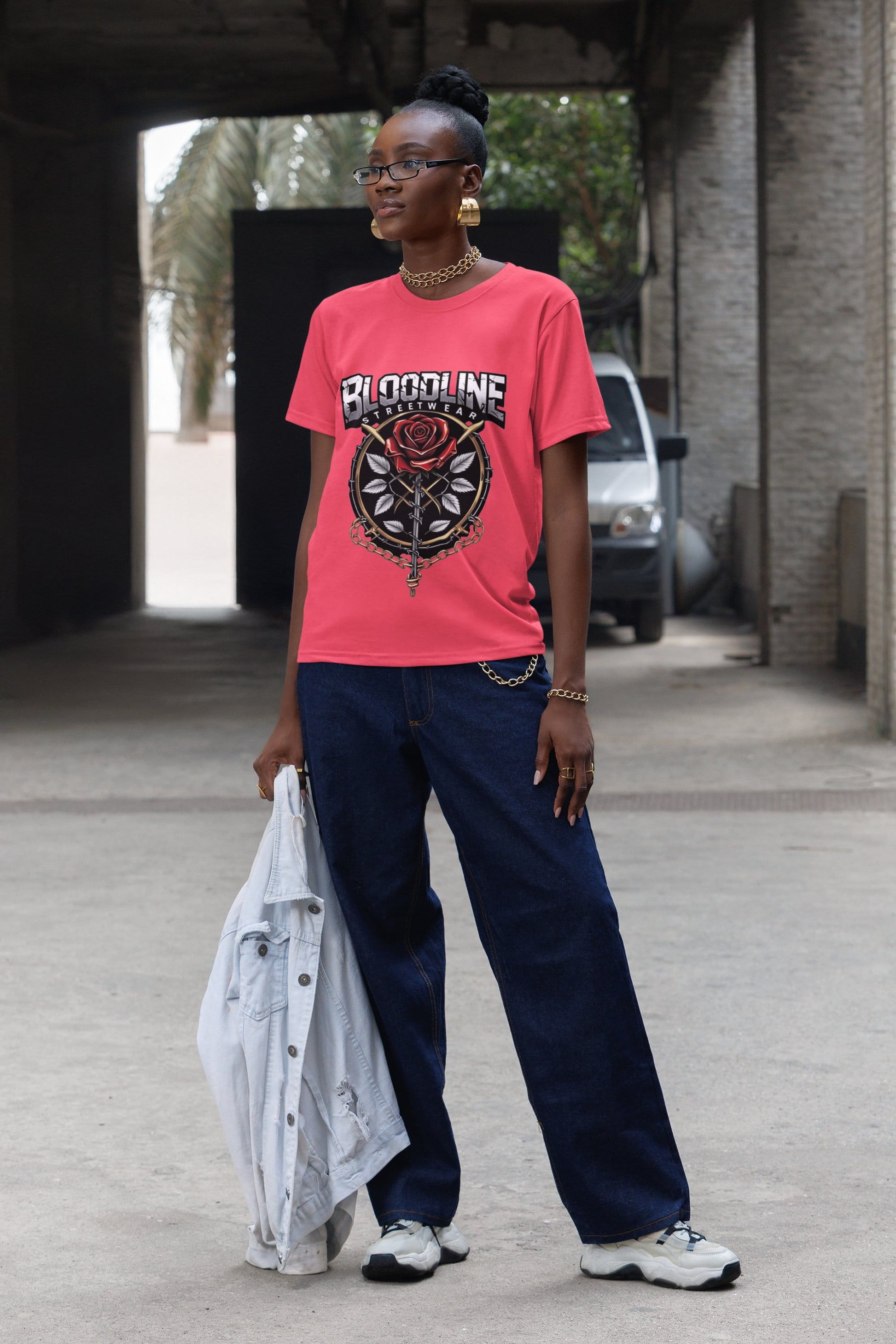 Person wearing a red 'Bloodline' t-shirt and dark pants, standing outdoors.