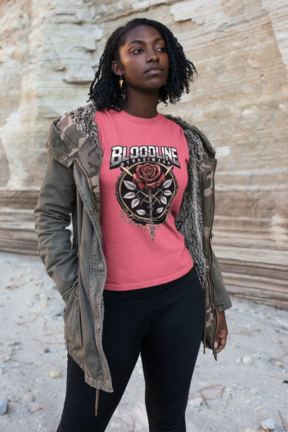 Person wearing a pink t-shirt with 'Bloodline' design outdoors.