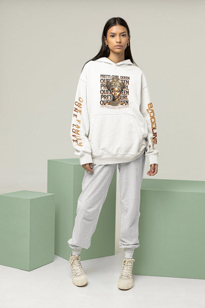 Person wearing a white hoodie with graphic design and text, standing in front of a green surface.