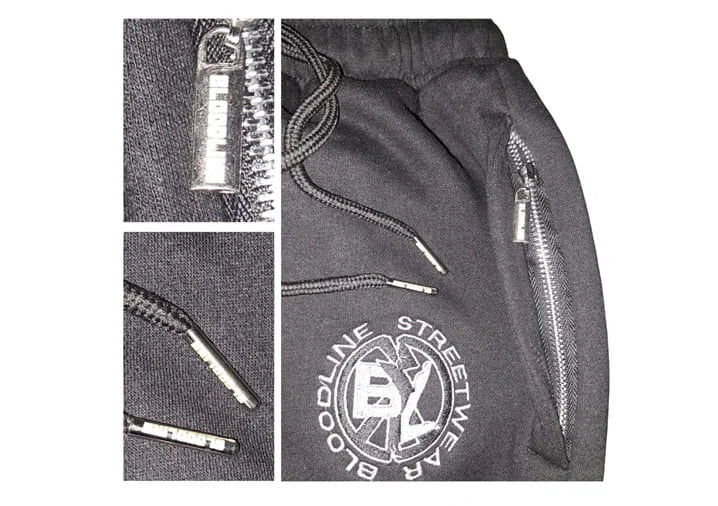 Gray pants with zippers and a brand logo on a white background