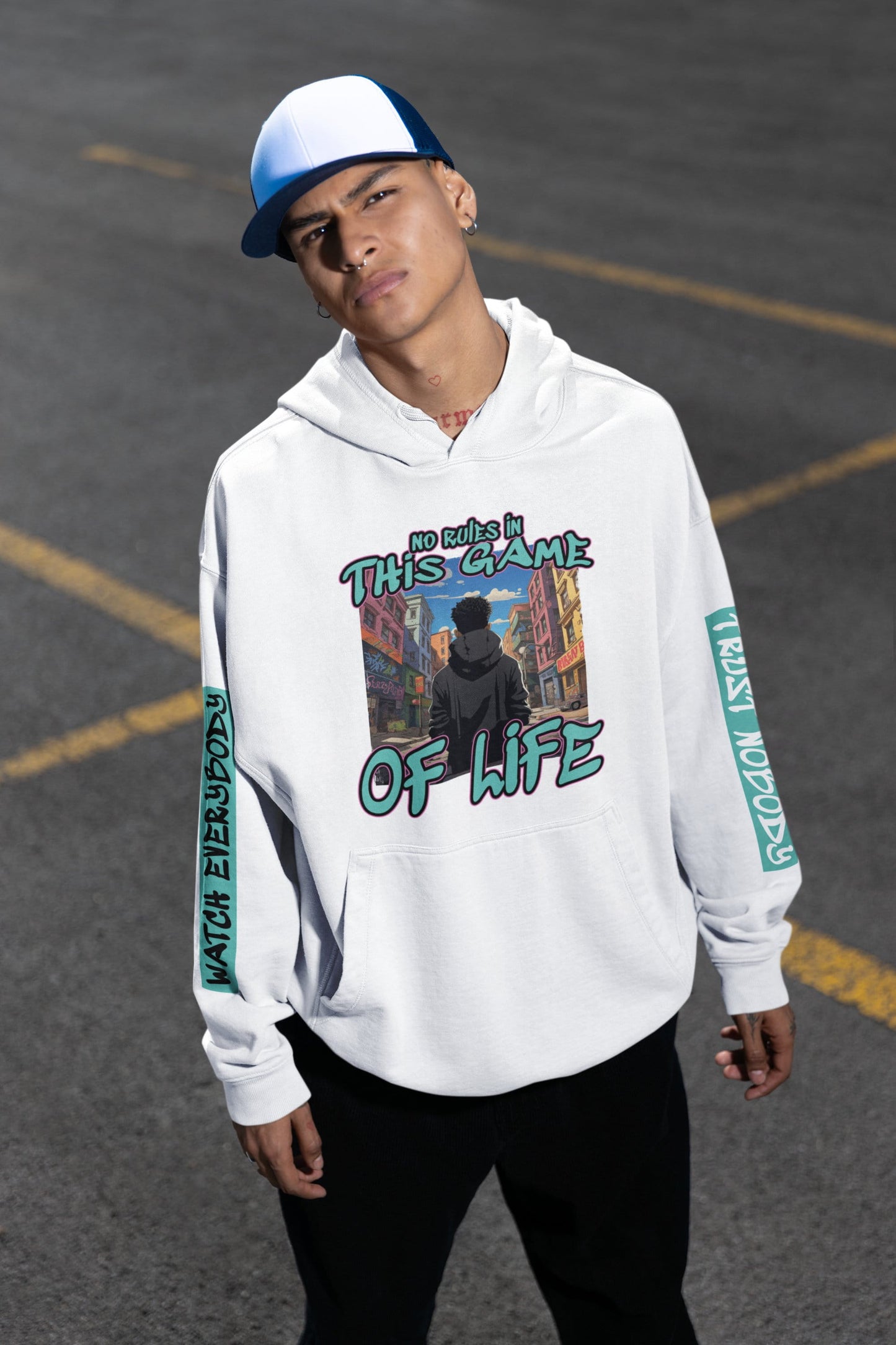Person wearing a white hoodie with graphic design and text on a street background