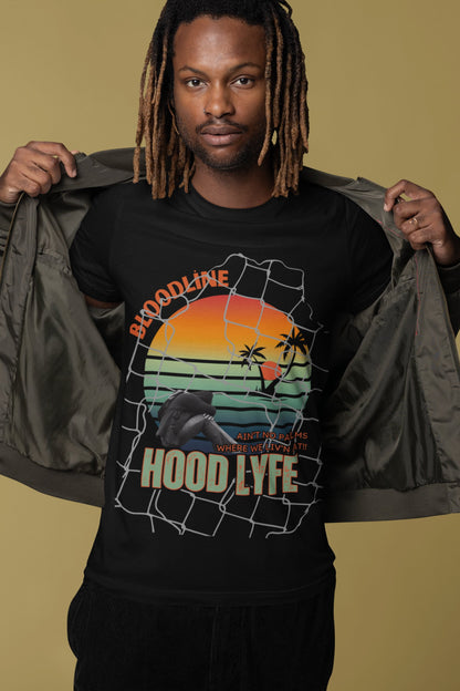 Man wearing a black t-shirt with a graphic design and text, holding a jacket.