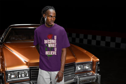 Man wearing a purple t-shirt with motivational text in front of a classic car.