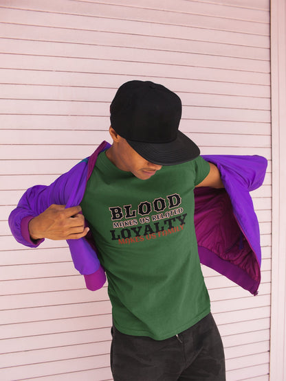 Person wearing a green t-shirt with text, holding a purple jacket against a light wooden panel background