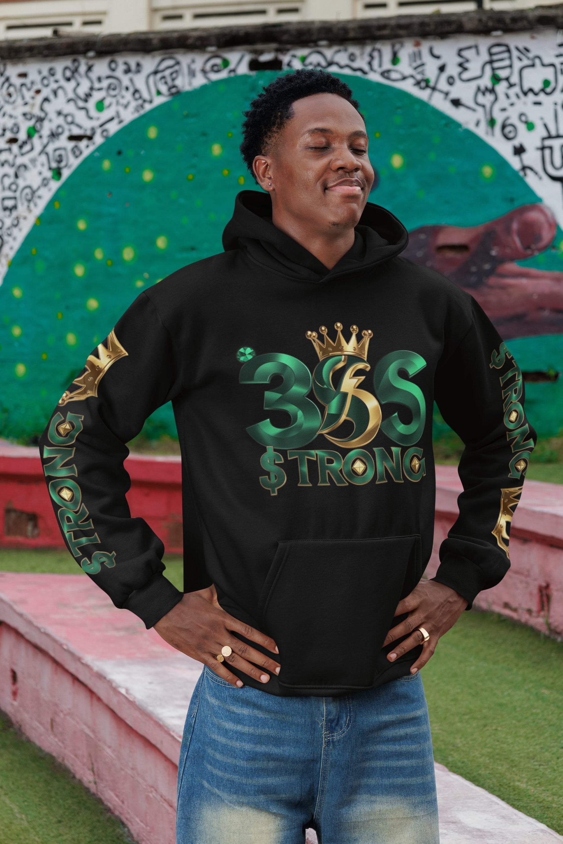Person wearing a black hoodie with '35 Strong' design in front of a colorful mural.