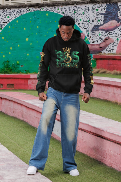 Person wearing a black hoodie with green text and blue jeans standing in front of a colorful mural.