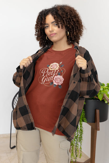 Woman wearing a red 'Pretty Girl' t-shirt with a floral design, standing indoors.