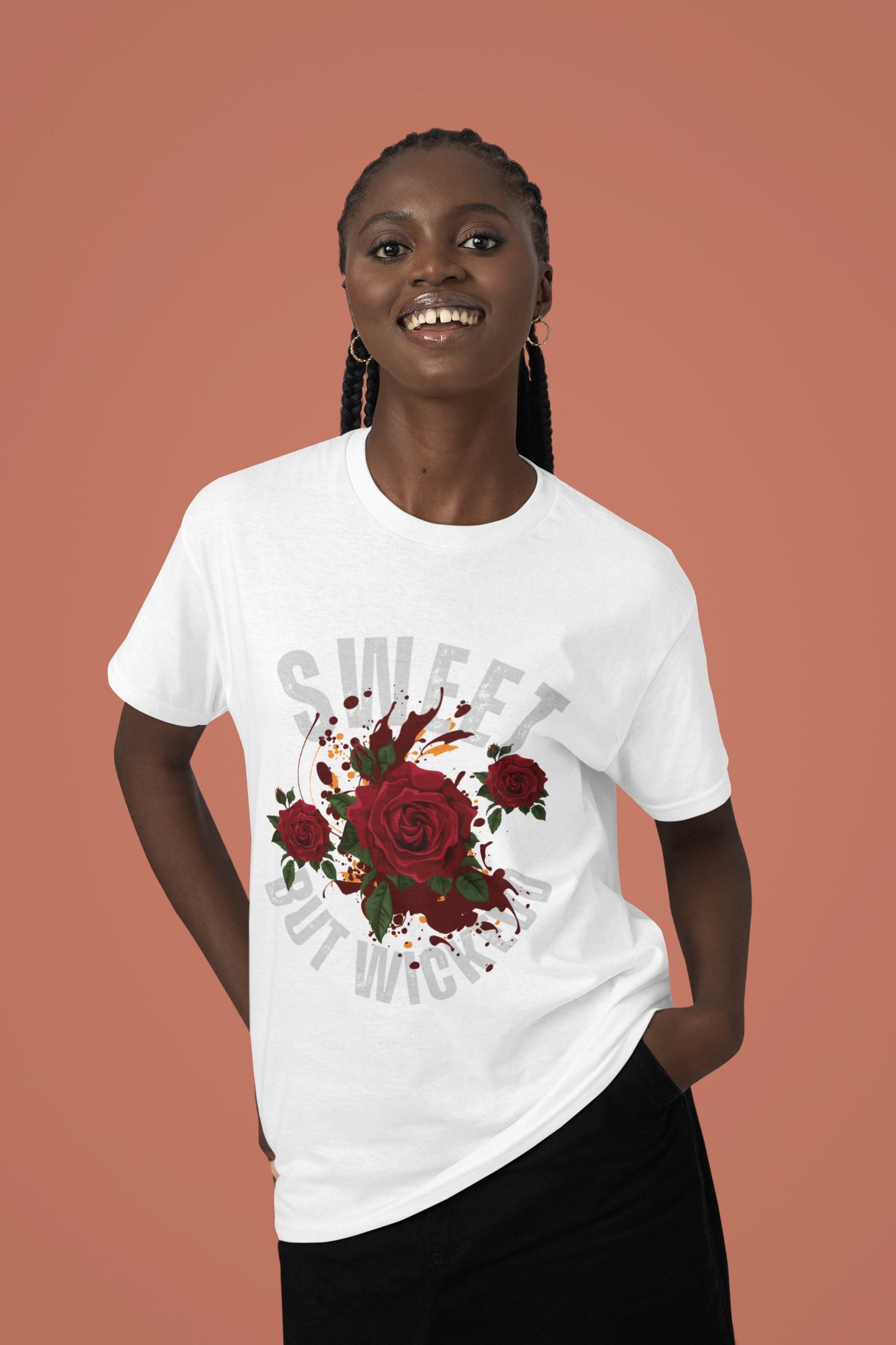 Person wearing a white t-shirt with red floral design and text on a brown background
