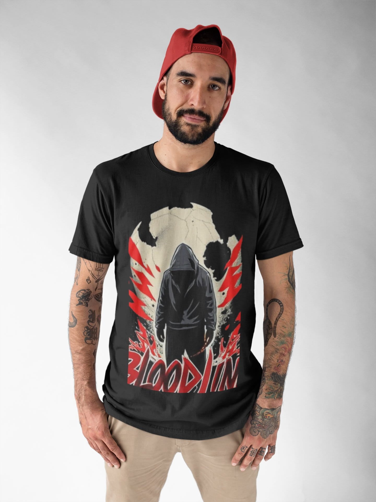 Man wearing a black t-shirt with a graphic design and text, standing against a plain background