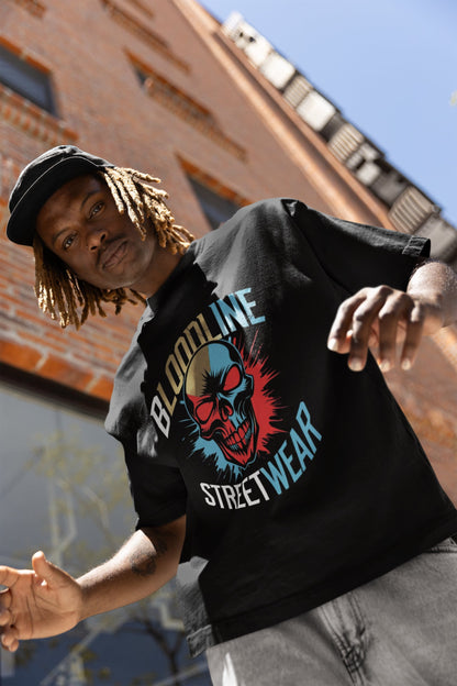 Person wearing a black 'Bloodline Streetwear' t-shirt with a graphic design, standing against a brick wall.