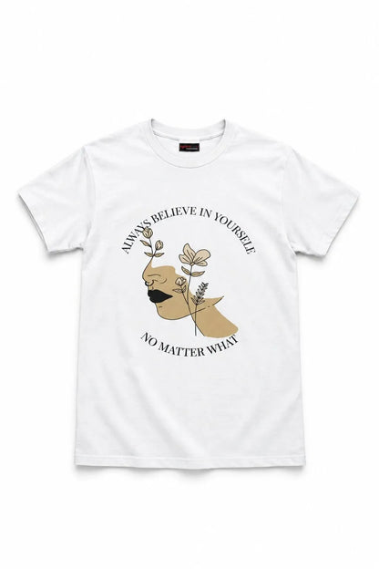 A white short-sleeve crewneck t-shirt featuring a graphic print of a stylized face with a mustache, surrounded by flowers and the text 'ALWAYS BELIEVE IN YOURSELF NO MATTER WHAT'.