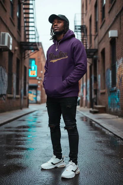 A man standing in a wet urban alley wearing a purple hoodie with 'Blackline' written across the chest, black ripped jeans, white sneakers, and a dark cap.