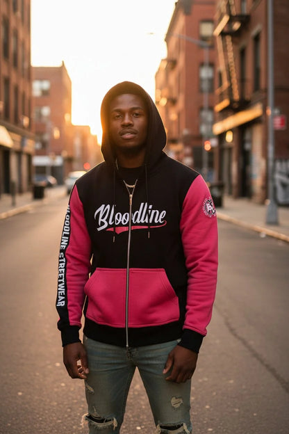 Person wearing a black and pink 'Bloodline' jacket on a city street.
