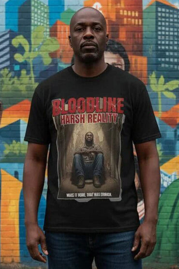 Man wearing a black t-shirt with graphic design and text in front of a colorful mural.