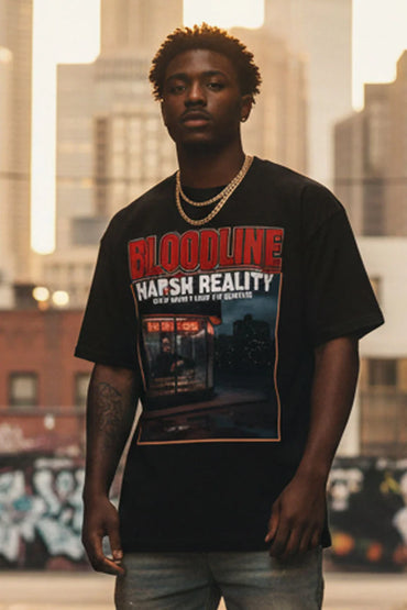 Man wearing a black t-shirt with graphic design and text, standing in an urban setting.