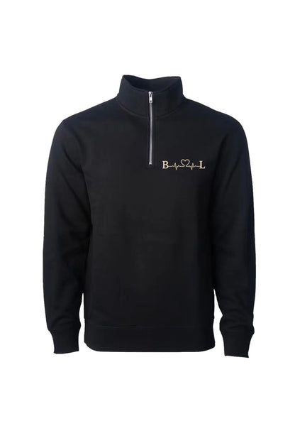A black long-sleeve quarter-zip sweatshirt with a mock neck collar, featuring a gold embroidered 'B❤♥L' logo on the left chest, displayed on a clean white background.