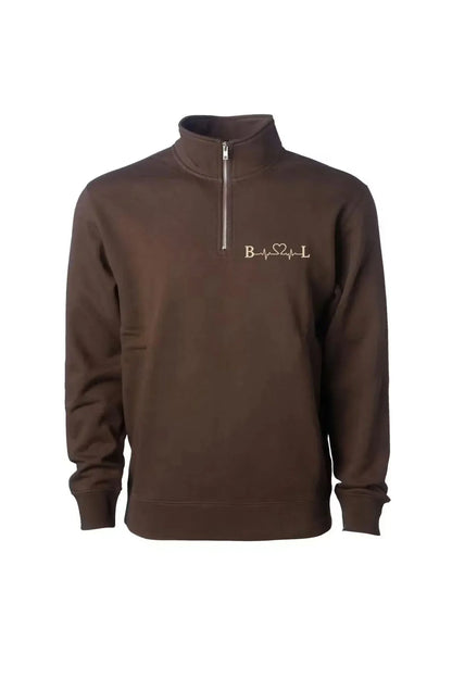A dark brown long-sleeve quarter-zip sweatshirt with a mock neck collar, featuring a small gold embroidered logo on the left chest, displayed on a clean white background.