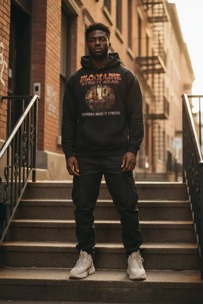 Man wearing a hoodie with a graphic design on a city street