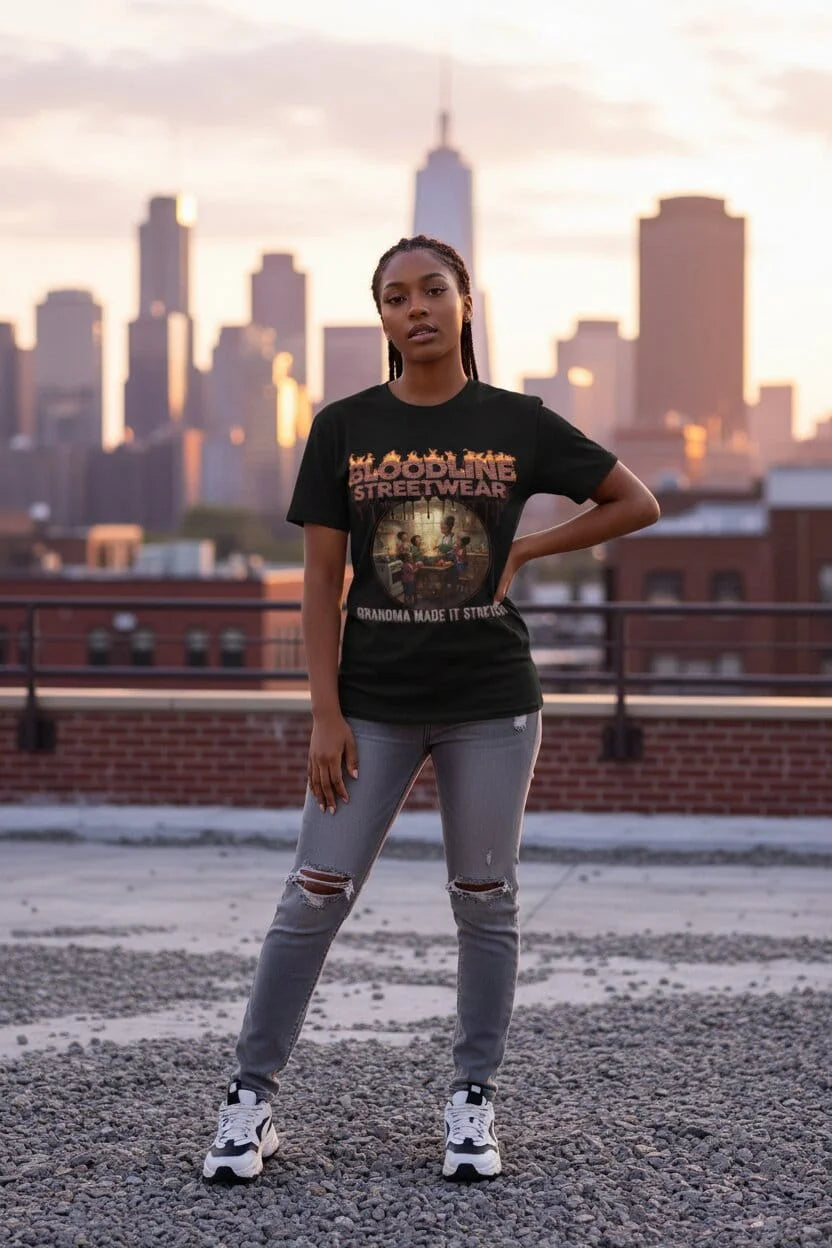 Person wearing a black t-shirt with text and graphics, standing on a rooftop with a city skyline in the background.