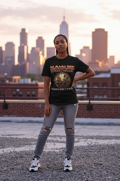 Person wearing a black t-shirt with text and graphics, standing on a rooftop with a city skyline in the background.