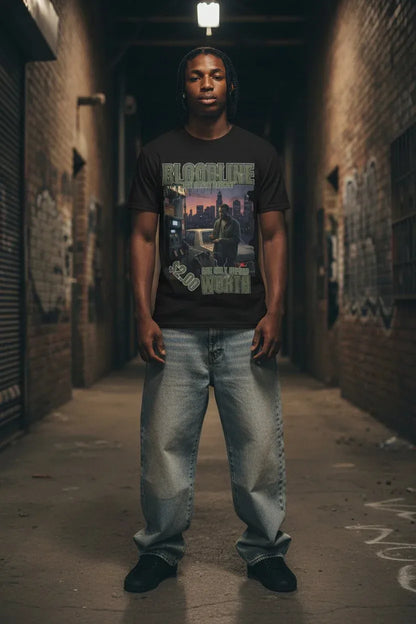 A man stands in a dark urban alley wearing a black graphic t-shirt with 'BLOODLINE' text, paired with light-wash baggy jeans and black shoes.