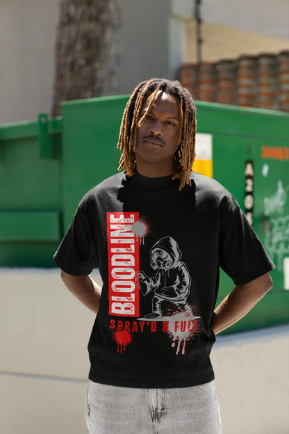 Person wearing a black t-shirt with graphic design and text, standing outdoors.
