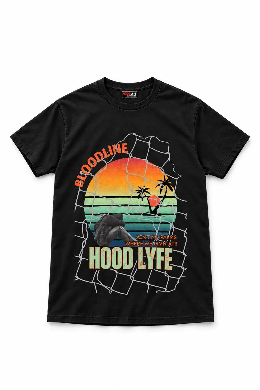 A black short-sleeve crewneck t-shirt featuring a large graphic print on the front. The graphic depicts a sunset over a beach with palm trees, a shark, and a fishnet overlay, with the text 'BLOODLINE', 'HOOD LYFE', and 'WHERE WEYMTIN' printed in orange, yellow, and green.